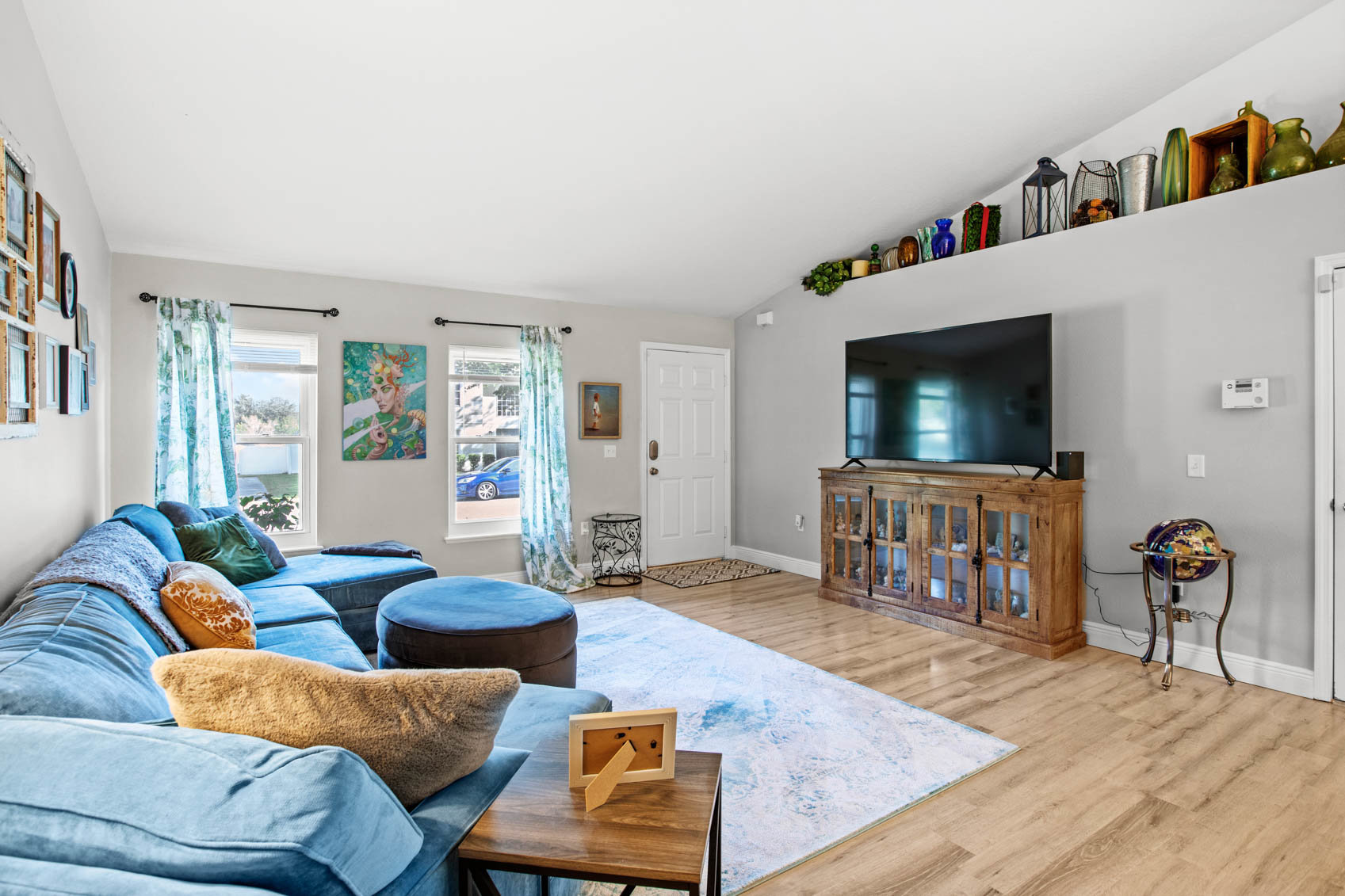 inside front door with living room and blue sectional